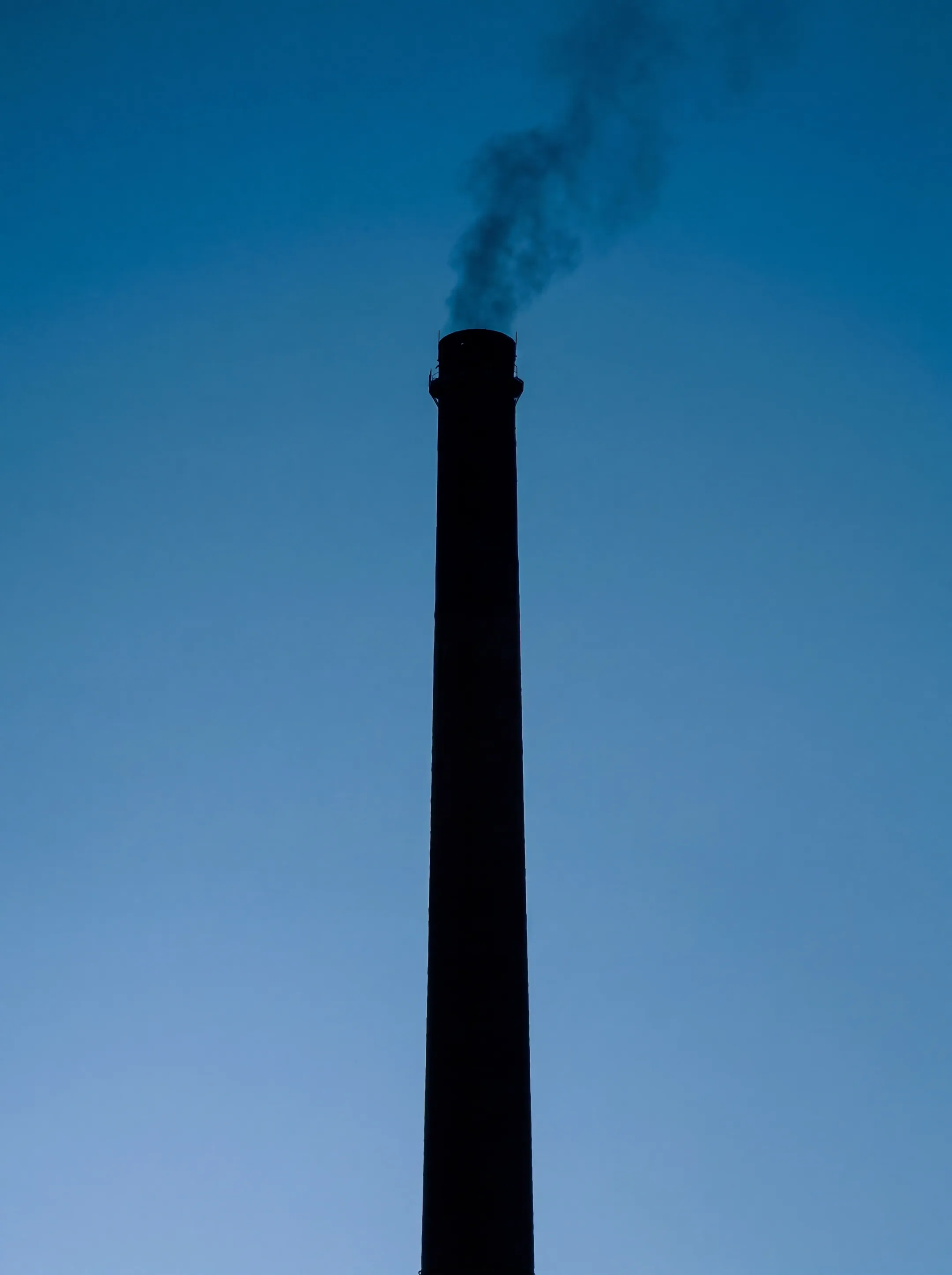 An industrial smokestack against the sky